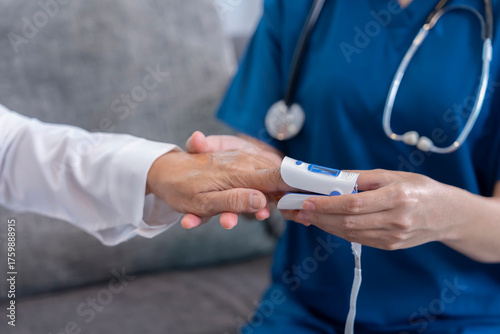 female hands in uniform with stethoscope is measuring pulse oximeter senior woman,healthcare worker or nurse physical examination old patient