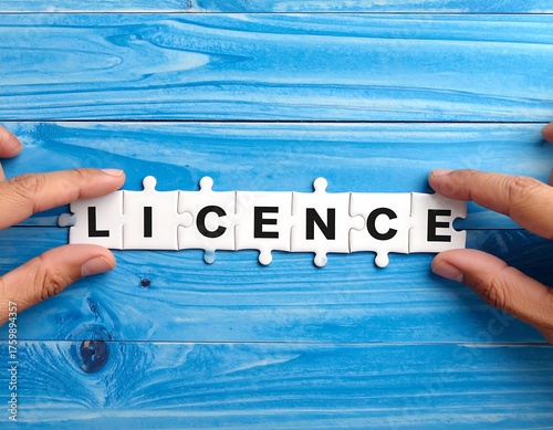 Hands placing a jigsaw puzzle spelling 