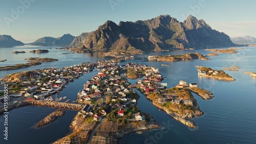 Henningsvær - Lofoten's most famous fishing village in Norway. Aerial shot of Henningsvaer beautiful coastal village surrounded by mountains and calm waters in Norway