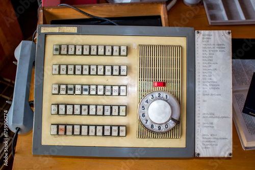 Retro Soviet factory intercom, a relic of bygone days. Dusty rotary phone, many buttons, embodying industrial decline and forgotten technology