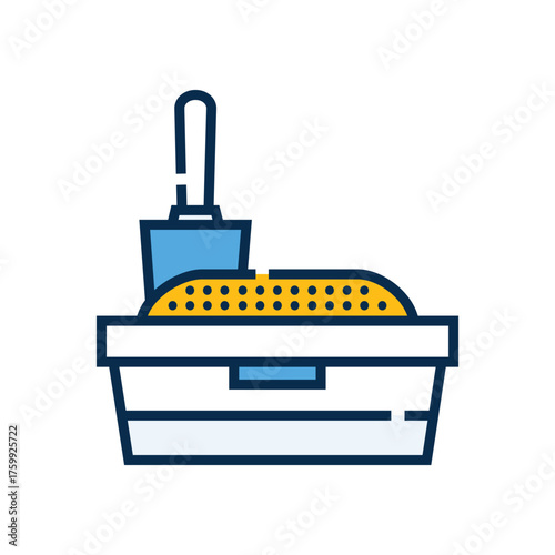 A cat litter box is filled with litter with a scoop sitting in it