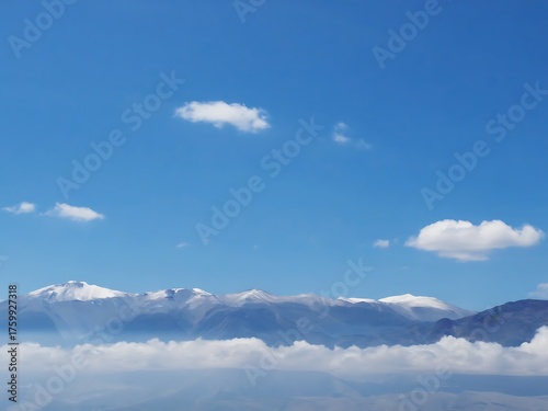 Majestic mountain peaks emerge from a sea of clouds under a clear blue sky