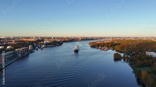 Passenger cruise ship leaving Stockholm harbour, Sweden via the many waterways through the archipelago, at sunrise in autumn