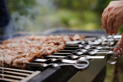 Slika na platnu Grilling juicy skewers under the sun during a lively summer barbecue with friend