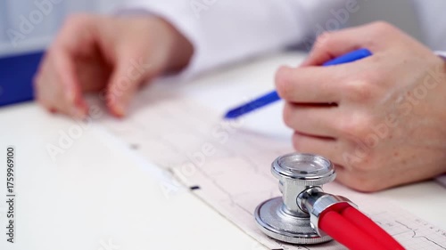 The doctor deciphers the cardiogram of the heart