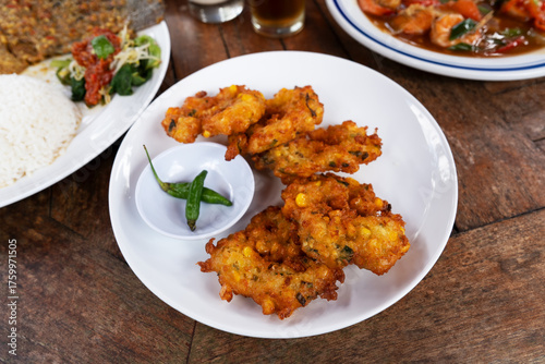 Canvastavla A plate of bakwan jagung or corn fritters Indonesian food
