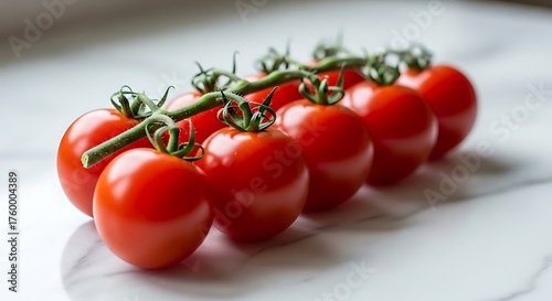 A vibrant cluster of fresh red cherry tomatoes on the vine, beautifully arranged on a white marble kitchen counter