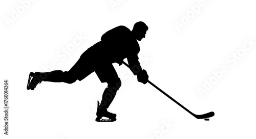 Silhouette of a hockey player skating and shooting