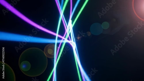 Glowing colorful streaks of light on a dark background, with lens flares adding depth