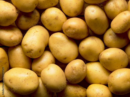 Photos Raw yellow potatoes background