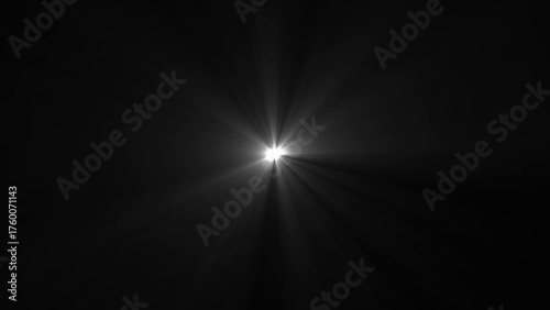 Bright white starburst light flare emanating from center against black background image