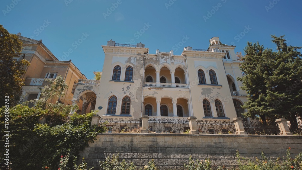 Fototapeta premium Abandoned mansion with decaying facade in Crimea peninsula is showing signs of neglect