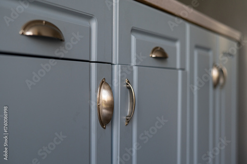 Close-Up of Blue Kitchen Cabinets with Brass Handles