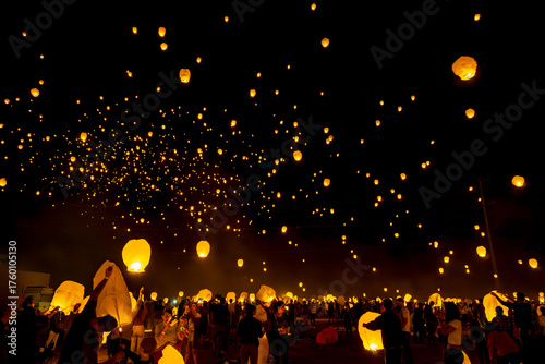 Sky lanterns rise over the desert night sky