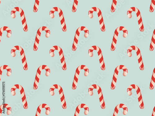 Seamless pattern with cartoon candy canes on blue background. Vector sweet Christmas background.