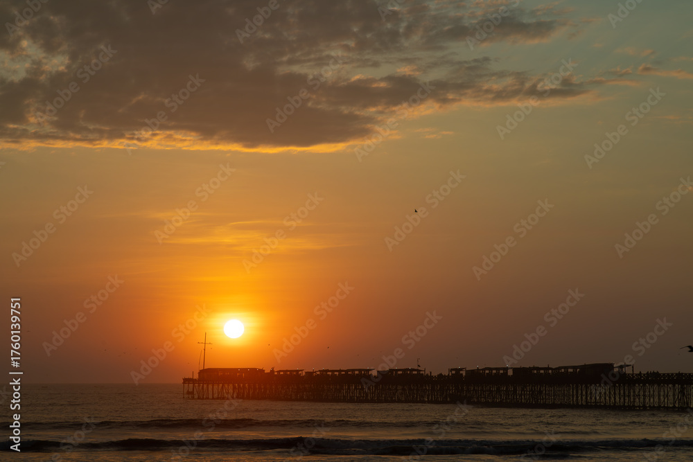 Fototapeta premium Pier of Pimentel at sunset in Lambayeque, Peru