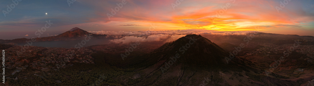 Fototapeta premium dramatic morning scene above erupting volcano with colorful clouds and awakening wilderness Kintamani Batur Abang Angung Bali