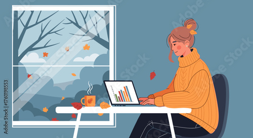 Cozy woman works remotely on laptop by the window during a chilly autumn day