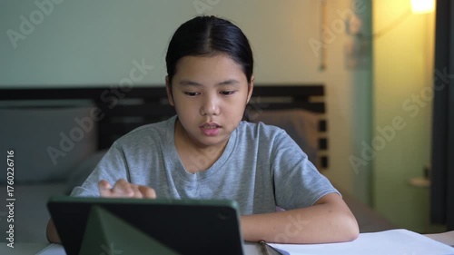asian child student write learning on computer tablet screen by touch pen or kid girl talking writing drawing on study online class by pad or young person learn from home school to speak in bedroom