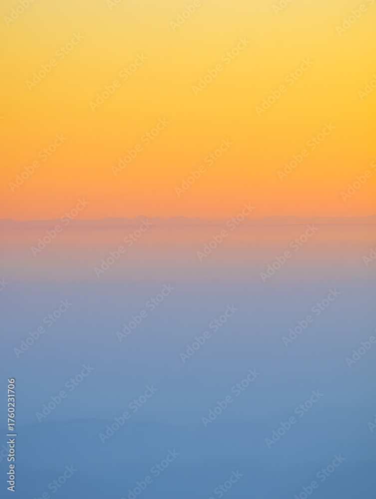 Fototapeta premium Aerial view of a colorful sunset with orange and blue hues creating a serene atmosphere