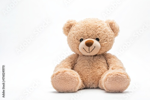 A teddy bear sitting on a white surface