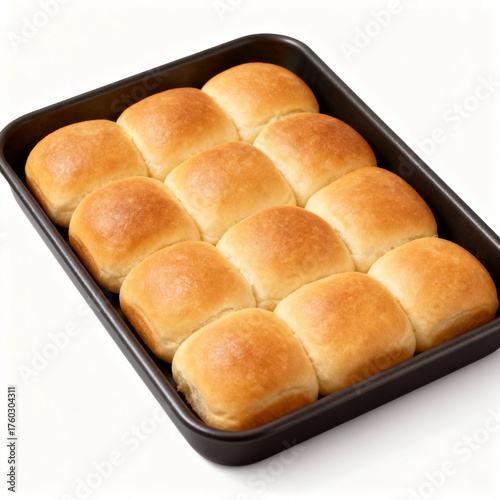 Freshly baked dinner rolls in a baking pan isolated on white background, ready to eat