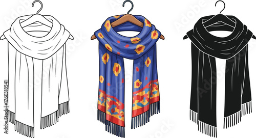 Three fringed shawls with unique patterns hanging on wooden hangers