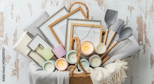 Basket filled with home decor items and candles on table