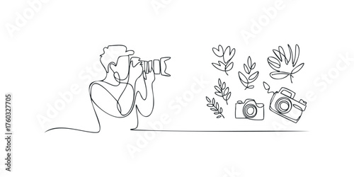 Person holding camera with botanical line drawings