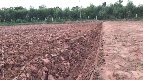 Freshly Plowed Earth: An image of rich, freshly plowed earth, revealing the raw potential for cultivation. The soil's texture contrasts with the horizon.