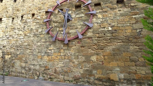 Philarmonia Wall Clock on the ancient city walls in Baku, Azerbaijan