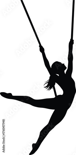 Silhouette of female aerial dancer performing on trapeze, elegant acrobatic pose showing strength, flexibility, balance, art, and graceful movement