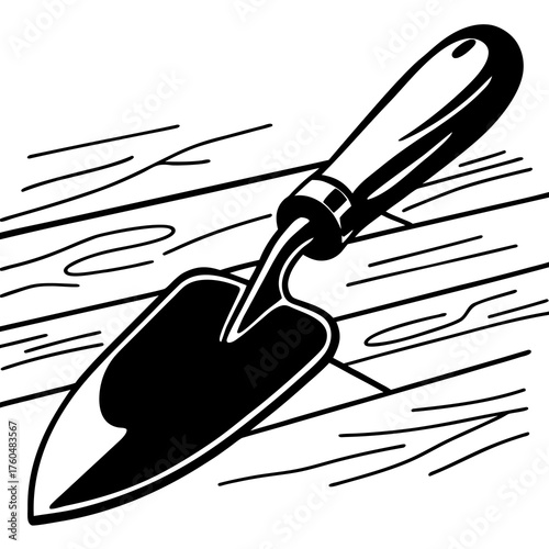 Hand trowel resting on wooden surface with simple line drawing  