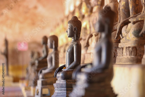 Golden ancient Buddha statue in a Lao temple with a serene meditation face, an iconic religious Asian sculpture representing peace and spirituality, Vientiane, Laos