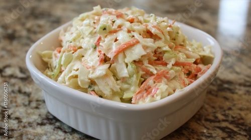 Shredded cabbage and carrots are mixed together in a creamy dressing creating a fresh coleslaw dish. This healthy side is perfect for summer meals or picnics.