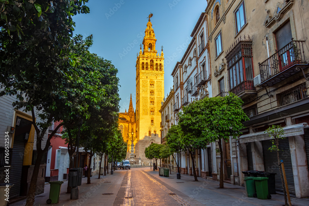 Naklejka premium Giralda tower of Gothic cathedral and streets of Seville, Spain
