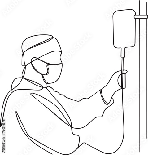 Medical professional in mask adjusting iv drip bag on stand