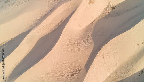 Fototapeta Naklejka Na Ścianę i Meble -  Aerial View of Beige Sand Dunes with Wavelike Patterns