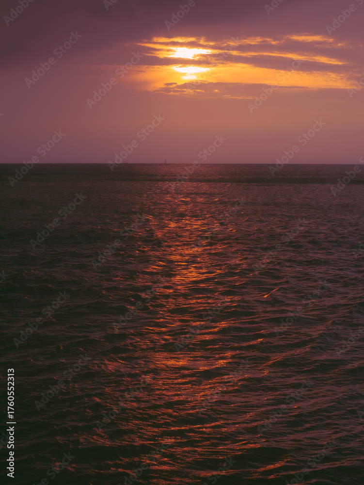 Fototapeta premium Sunset reflection on calm ocean surface