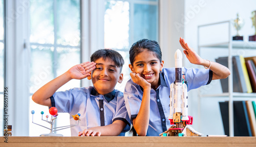 Indian students explore space rocket model in classroom while learning aerospace concepts in uniform