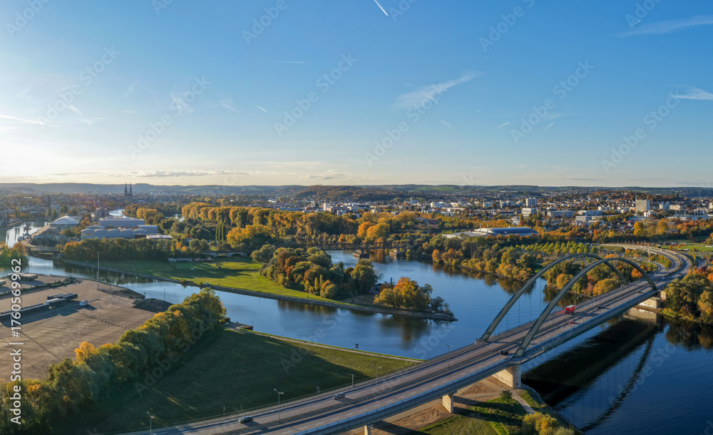 Fototapeta premium Modern Bridge and Riverside Cityscape in Autumn Colors