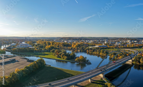 Modern Bridge and Riverside Cityscape in Autumn Colors
