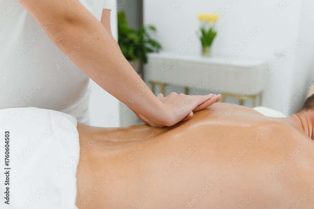 Fototapeta premium A man getting a back massage lying down at spa