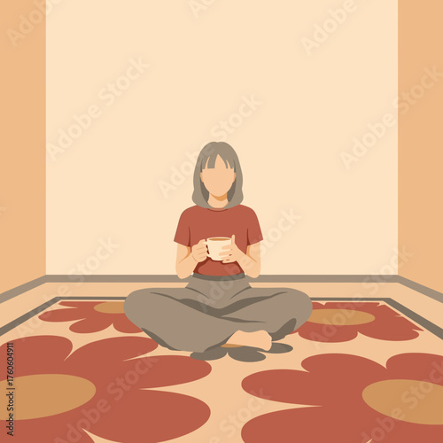 Young woman sitting cross-legged on floral rug with cup in hand  