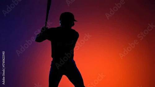 Baseball player silhouetted vibrant sunset