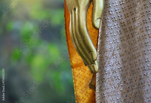 Closed up finger of the Buddha statue are painted gold.