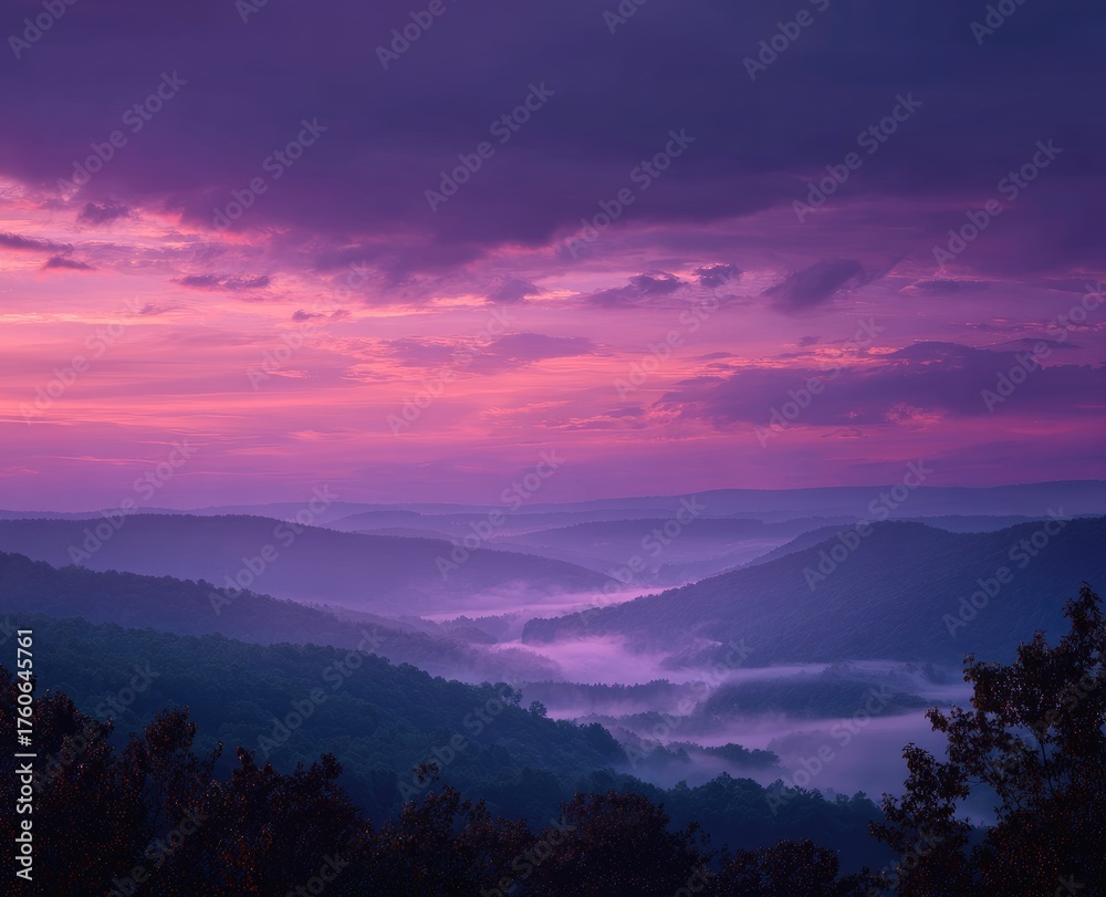 Naklejka premium Misty mountain valley at vibrant sunrise