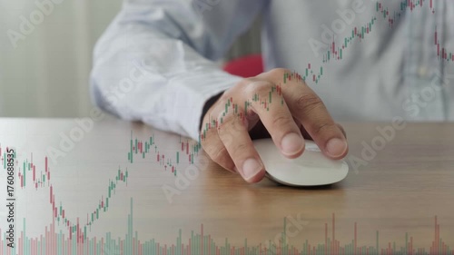 business man in shirt using hand on computer mouse at desk with stock chart overlay for finance analysis and investment decision in digital environment