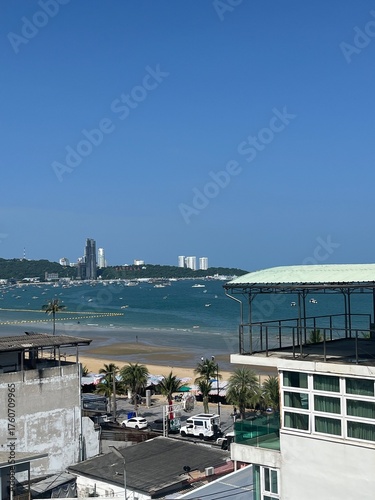 Sunny day overlooking vibrant coastal town with beach and ocean