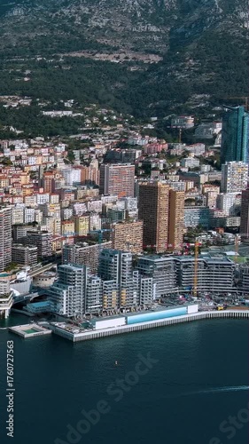 Stunning 4K vertical video aerial of Monaco's luxury skyline, Mediterranean waterfront with mountain backdrop. Premium drone footage perfect for mobile content showcasing Europe's billionaire haven.